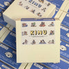 Box with 'KINU' branding on a stack of similar boxes.