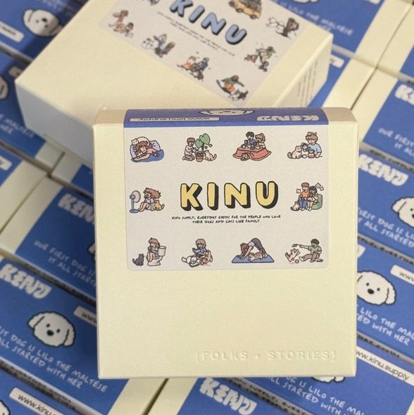 Box with 'KINU' branding on a stack of similar boxes.